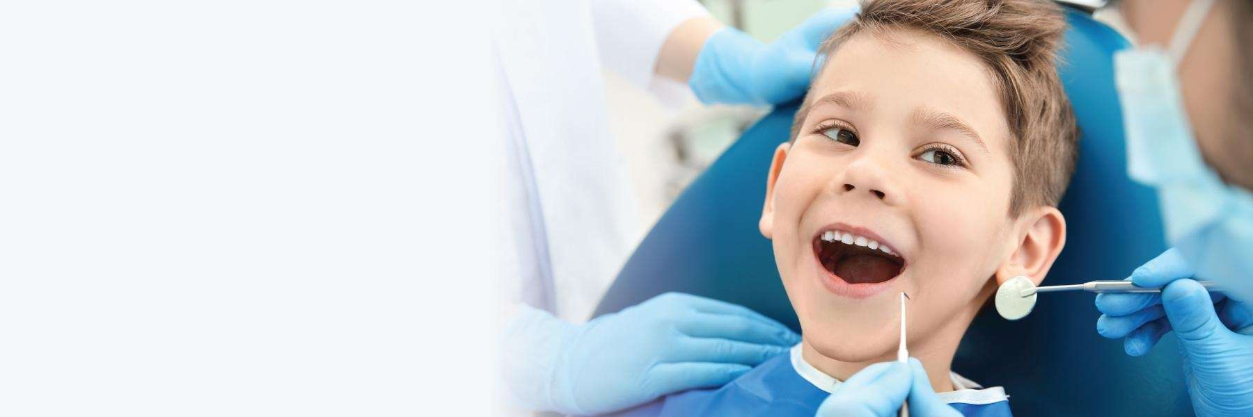 Young boy in dentist chair with mouth open, los gatos ca