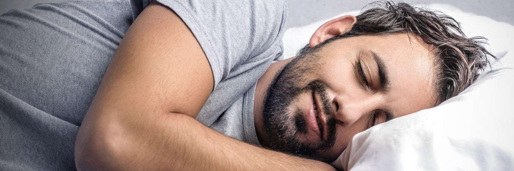 Man smiling while sleeping after bruxism treatment, los gatos ca