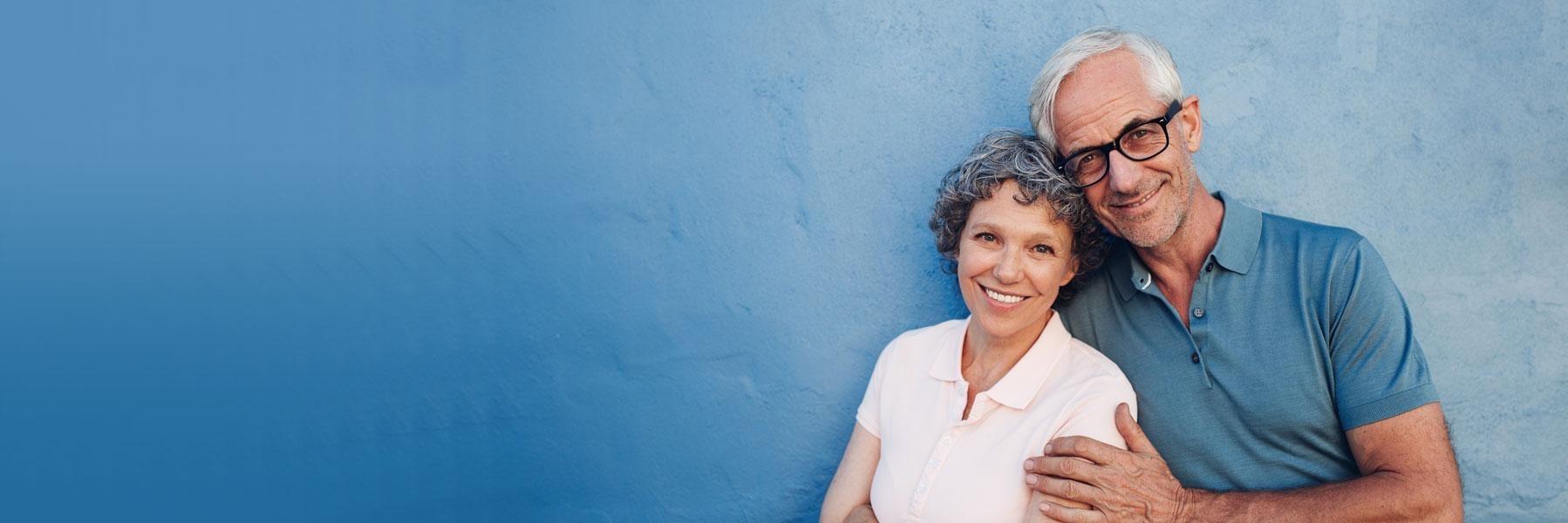 older couple with blue background l dental bridges los gatos ca