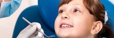 young girl smiling in dental exam chair l pediatric dentist los gatos