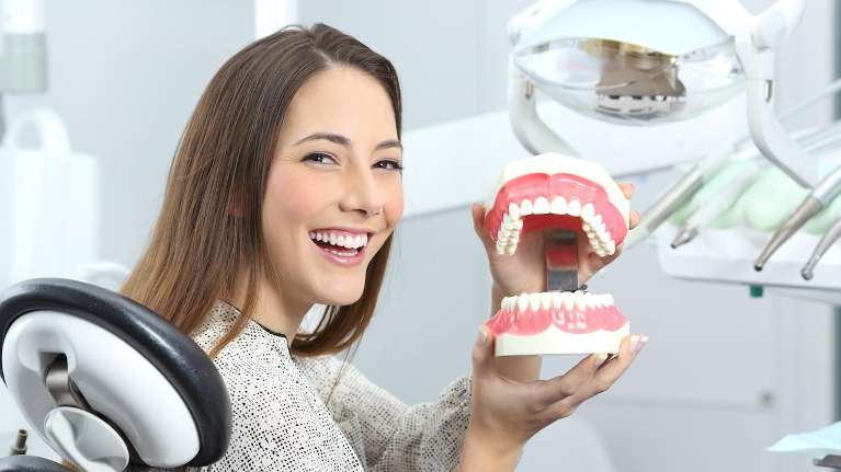 Woman smiling in a dental chair