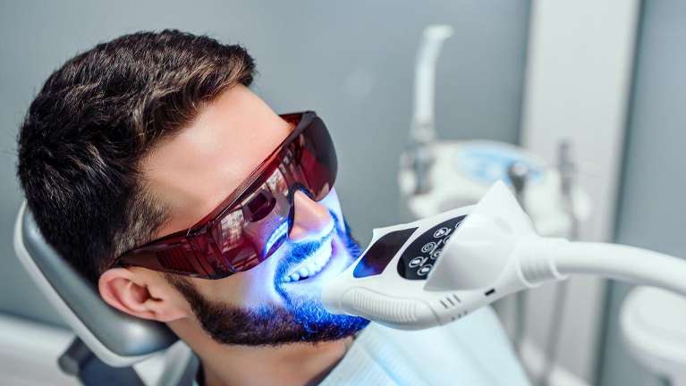 Man in dental chair getting teeth whitened, los gatos ca