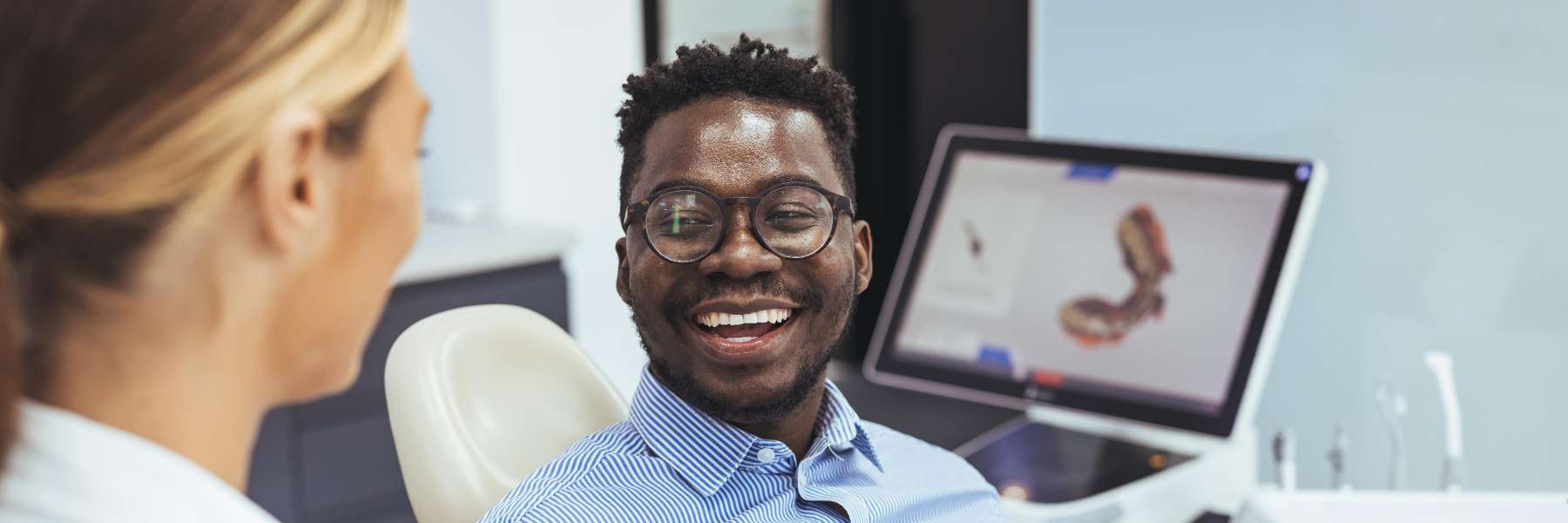 Male patient smiling during consultation showing a First Periodontal Visit