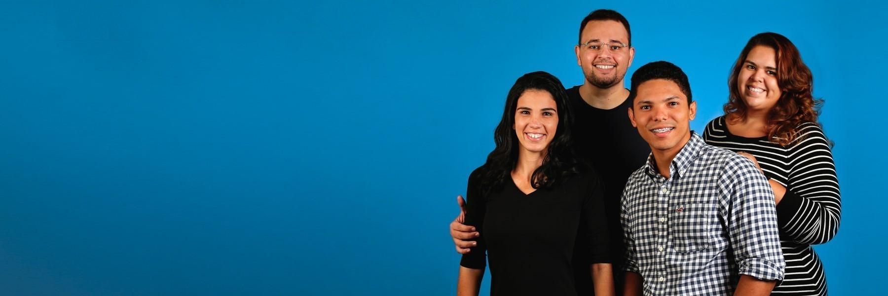 Mother, father, daughter, and son smiling with blue background | Dentist 95032